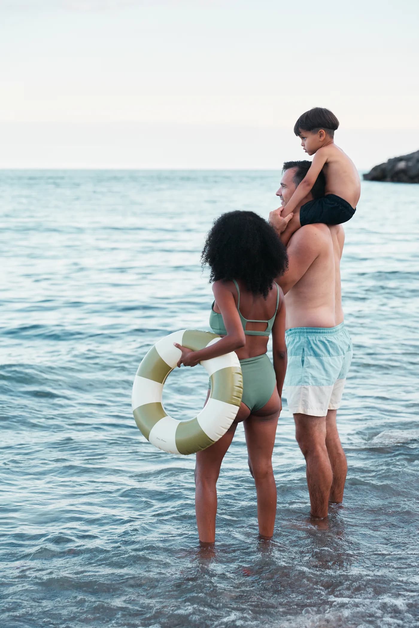 A family standing in Lake Ontario at the shoreline, official South Banks lifestyle photography.
