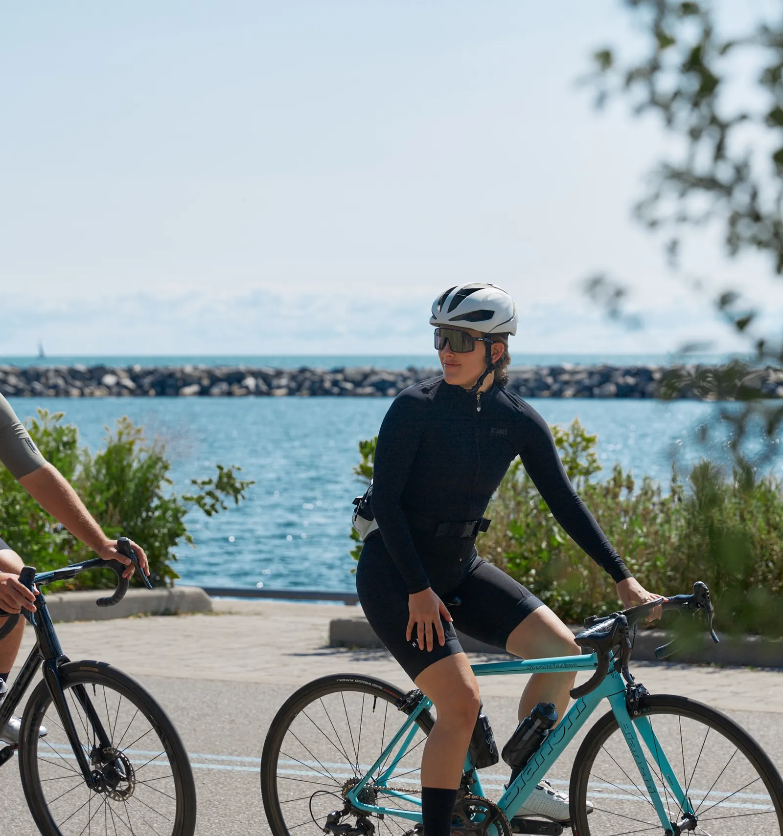 South Banks lifestyle photography along the Lake Ontario waterfront — cyclists on a shoreline path. Official project photography, not a specific unit.