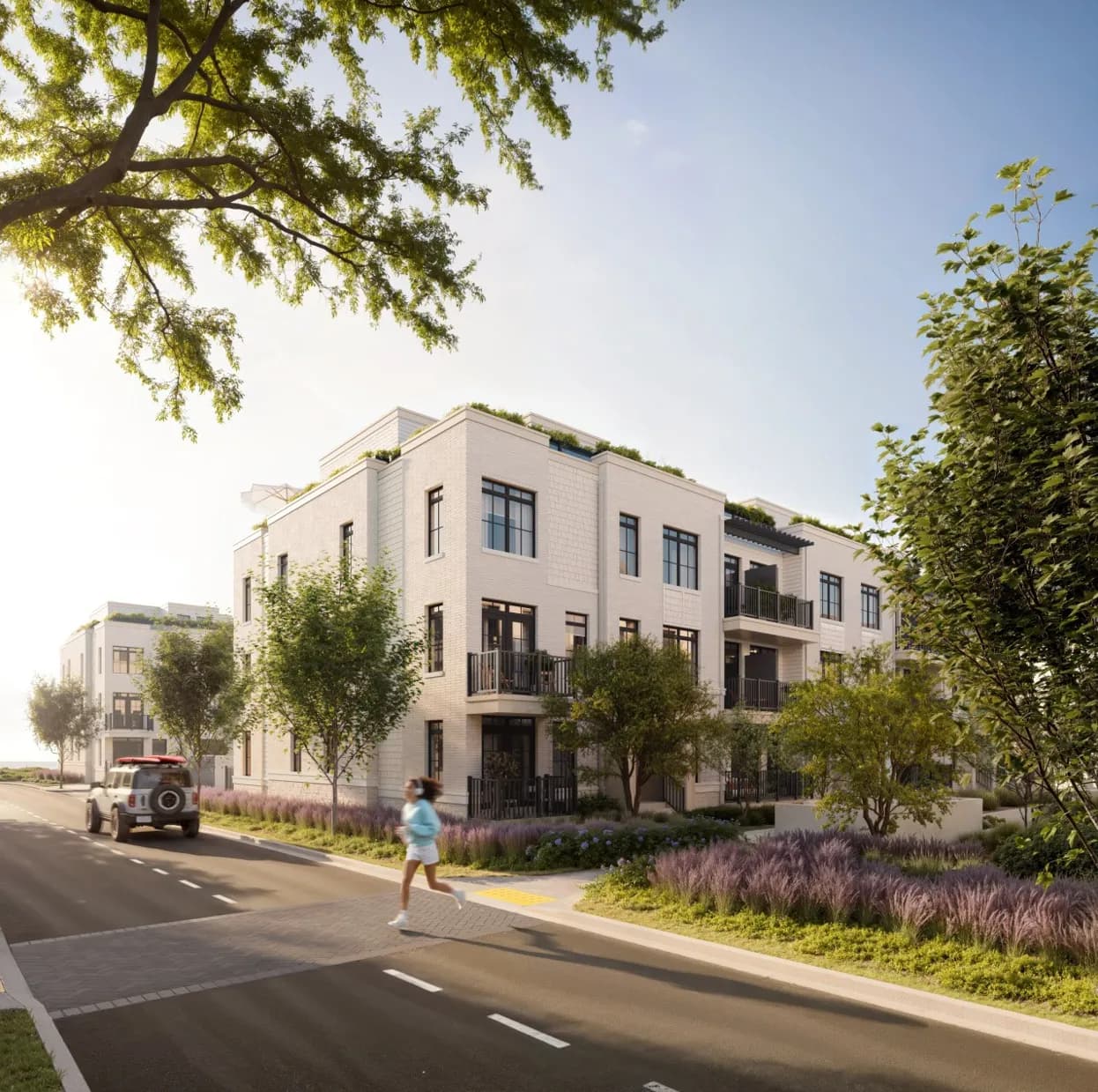 Architectural rendering of three-storey South Banks Towns freehold townhomes on a tree-lined street in Lakeview Village, Mississauga. Illustrative only.